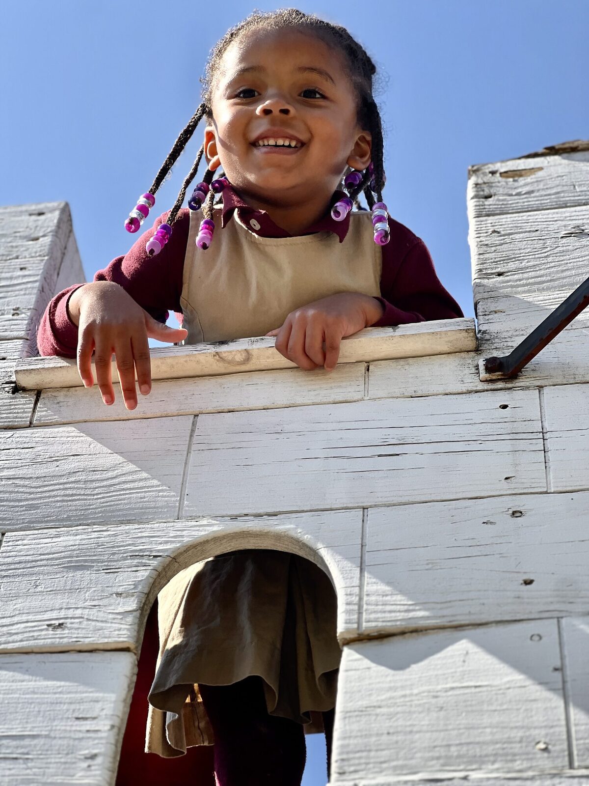 Student playing on the wooden playground